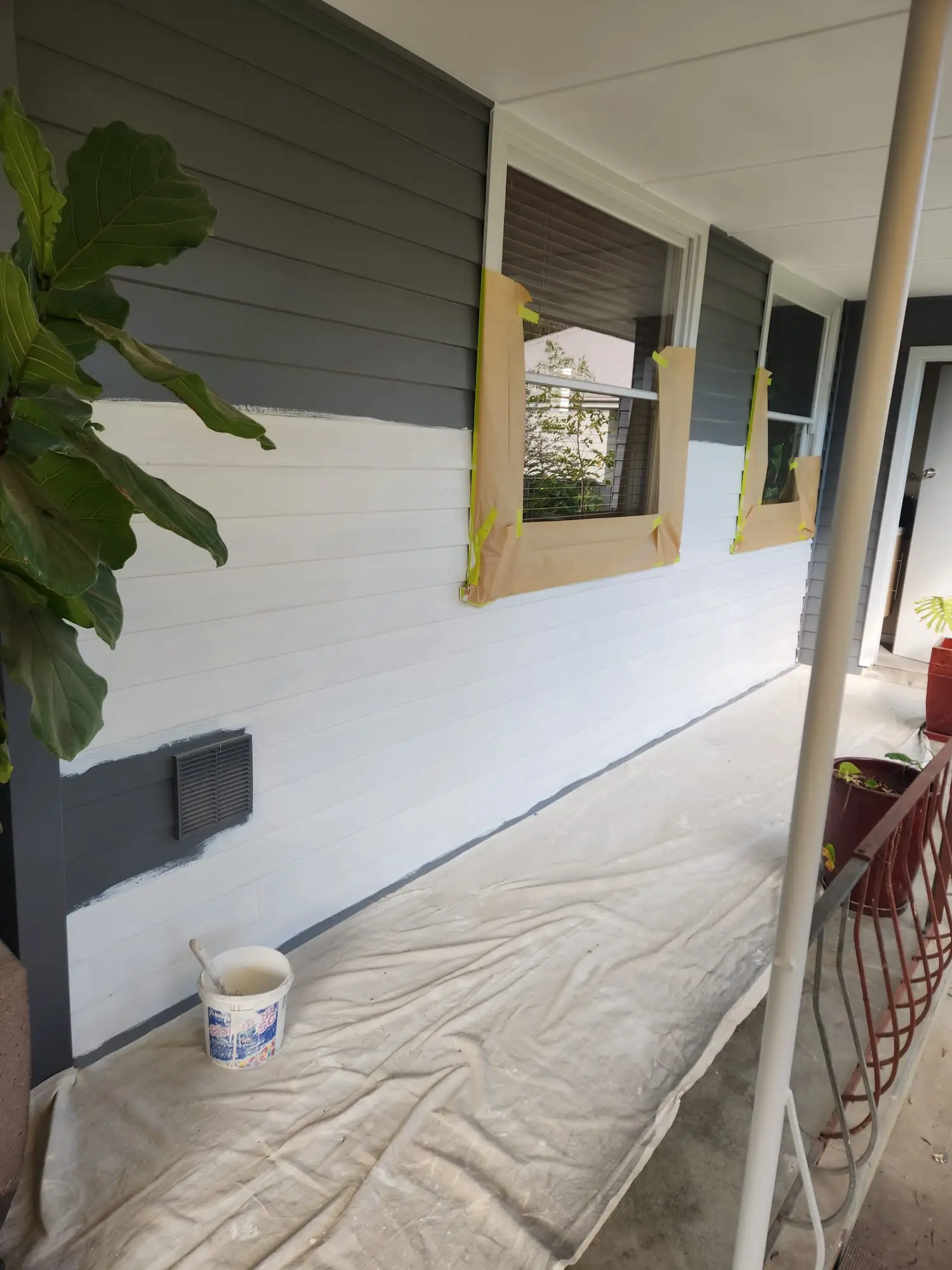 Commercial exterior windows masked and prepared before painting
