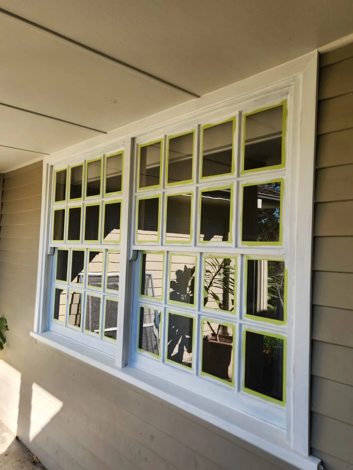Masking window frames during a coastal Newcastle exterior repaint