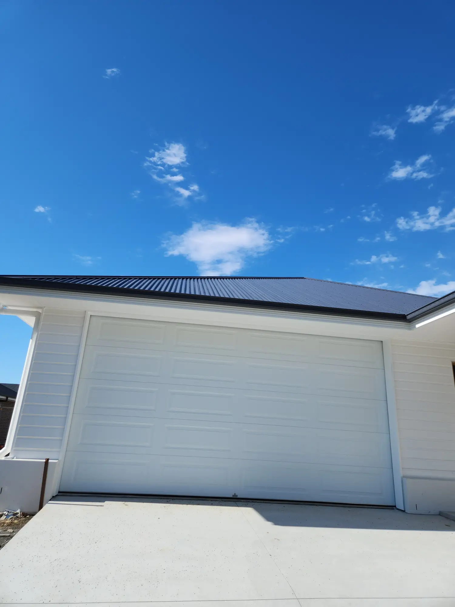 Freshly painted white garage door on a Newcastle home