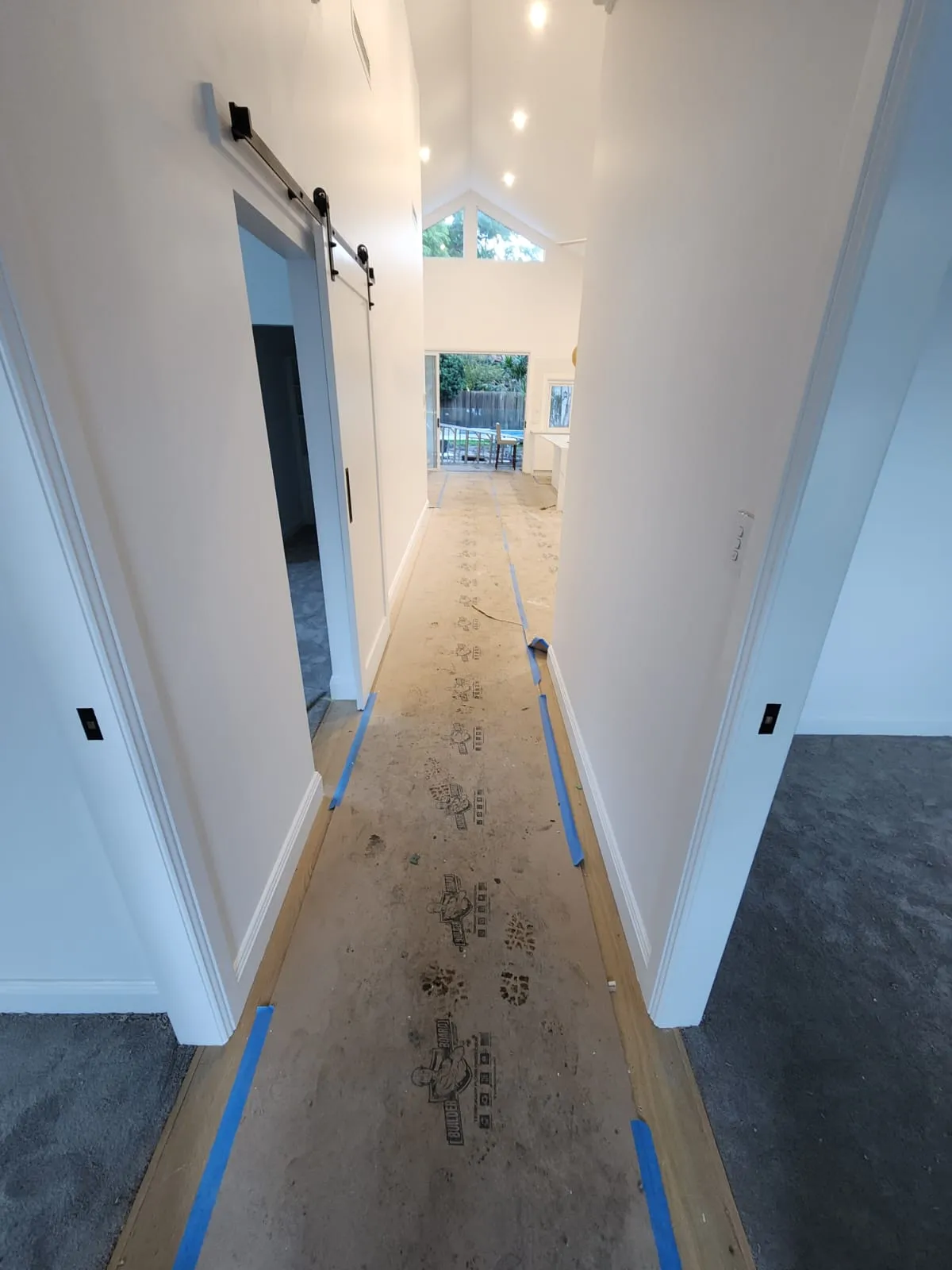 Interior hallway of a Newcastle property with floors protected during works
