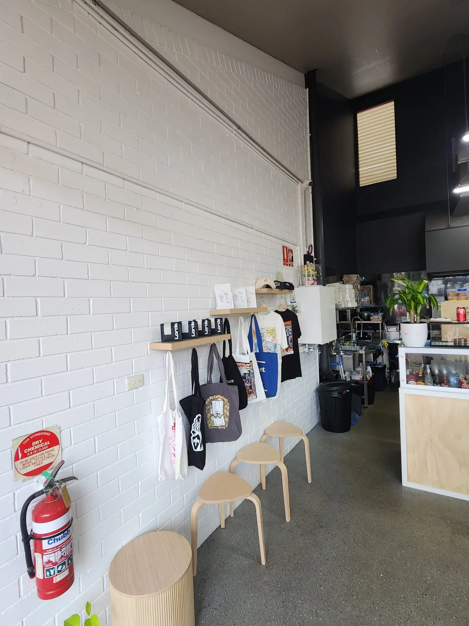 Painted cafe interior in Newcastle with white brickwork and dark ceiling