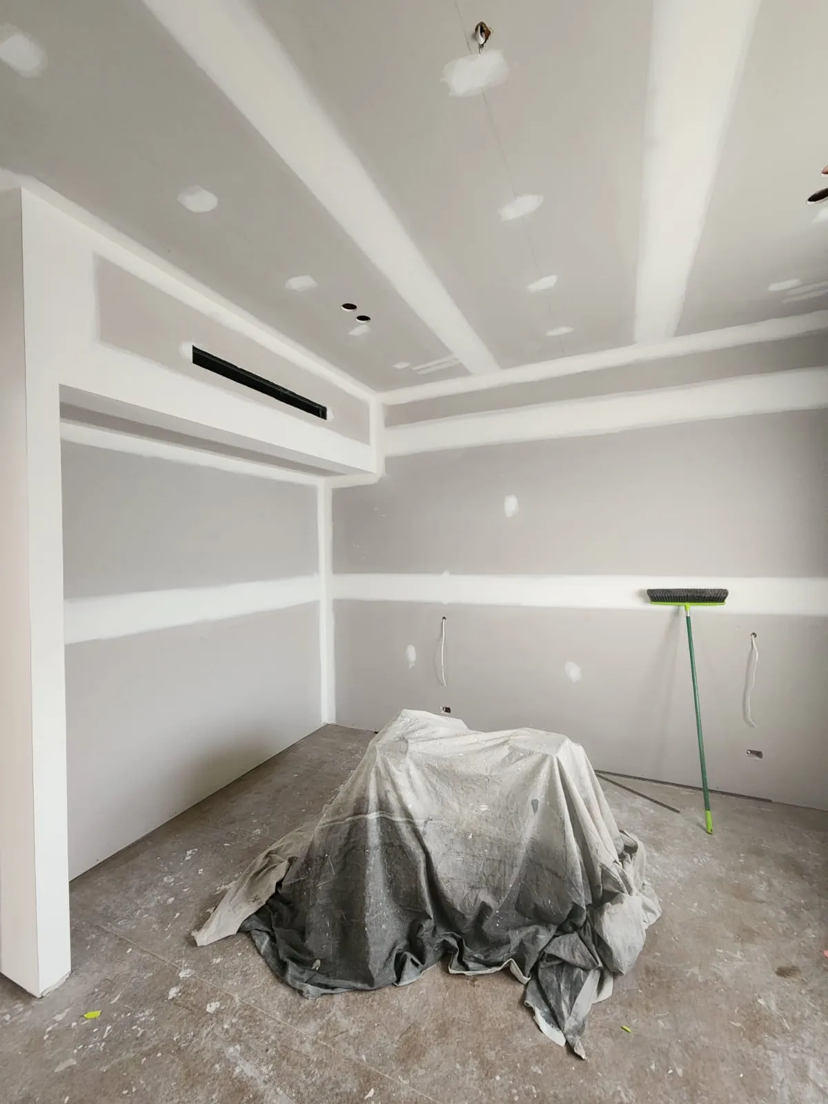 Interior room prepared with drop sheets before painting in a Newcastle home